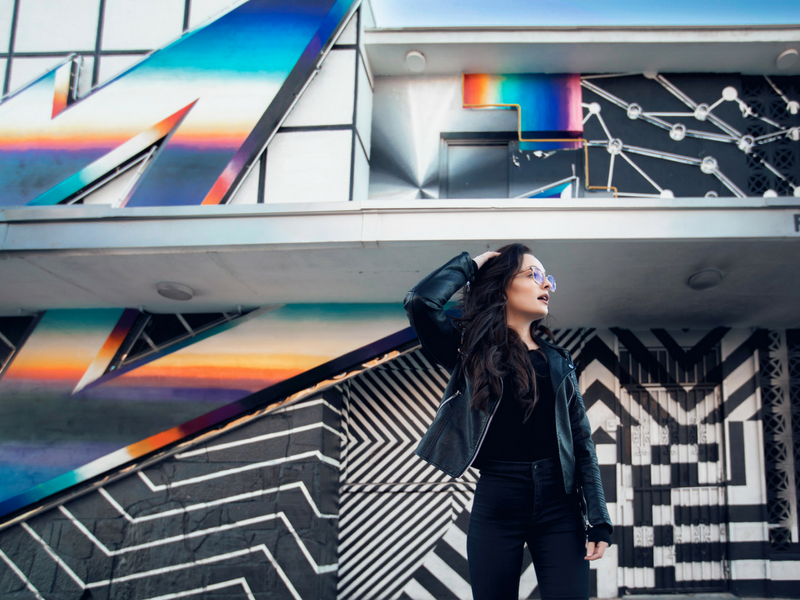 woman of generation z posing in front of a mural