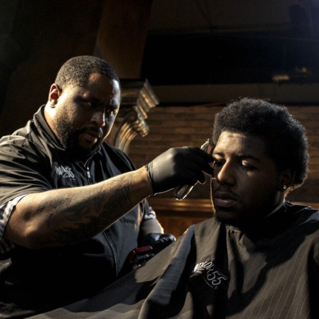 barbershop owner giving a fade