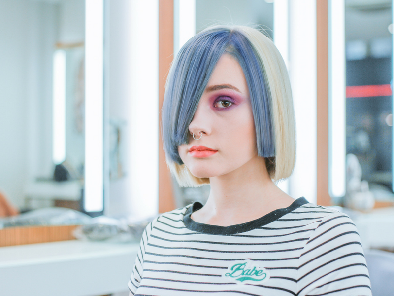 girl with blue and blonde hair sitting in a salon