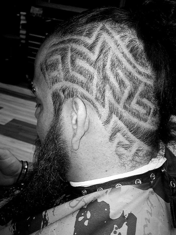 man with intricate design shaved in his head
