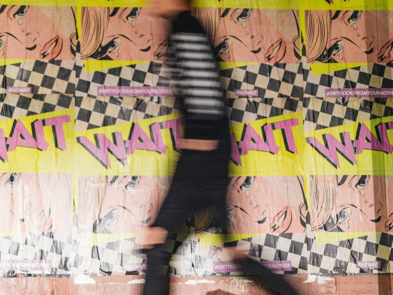 graphic wall with blurred man in foreground