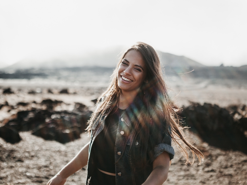 young woman laughing on the beach