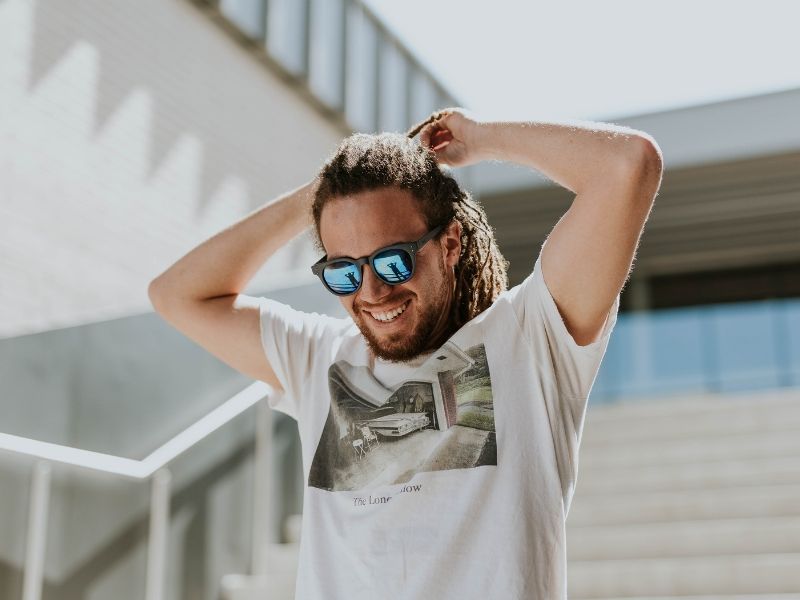 a man on a staircase wearing sunglasses