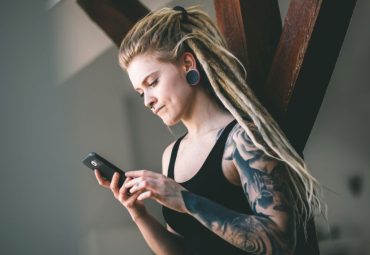 tattoo artist using mobile booking app bookedin